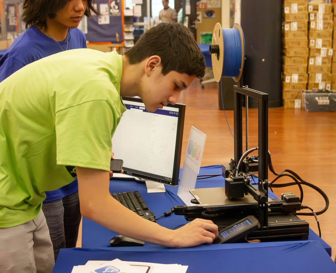Student working at a 3D printer